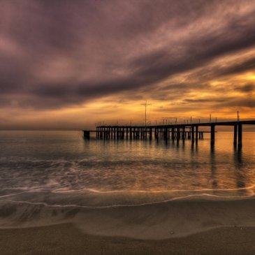 Pier, ocean, clouds and sunset